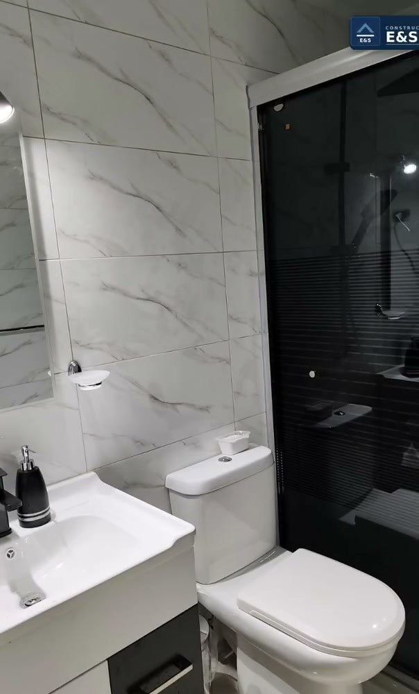 Lavamanos y mampara de vidrio en baño remodelado